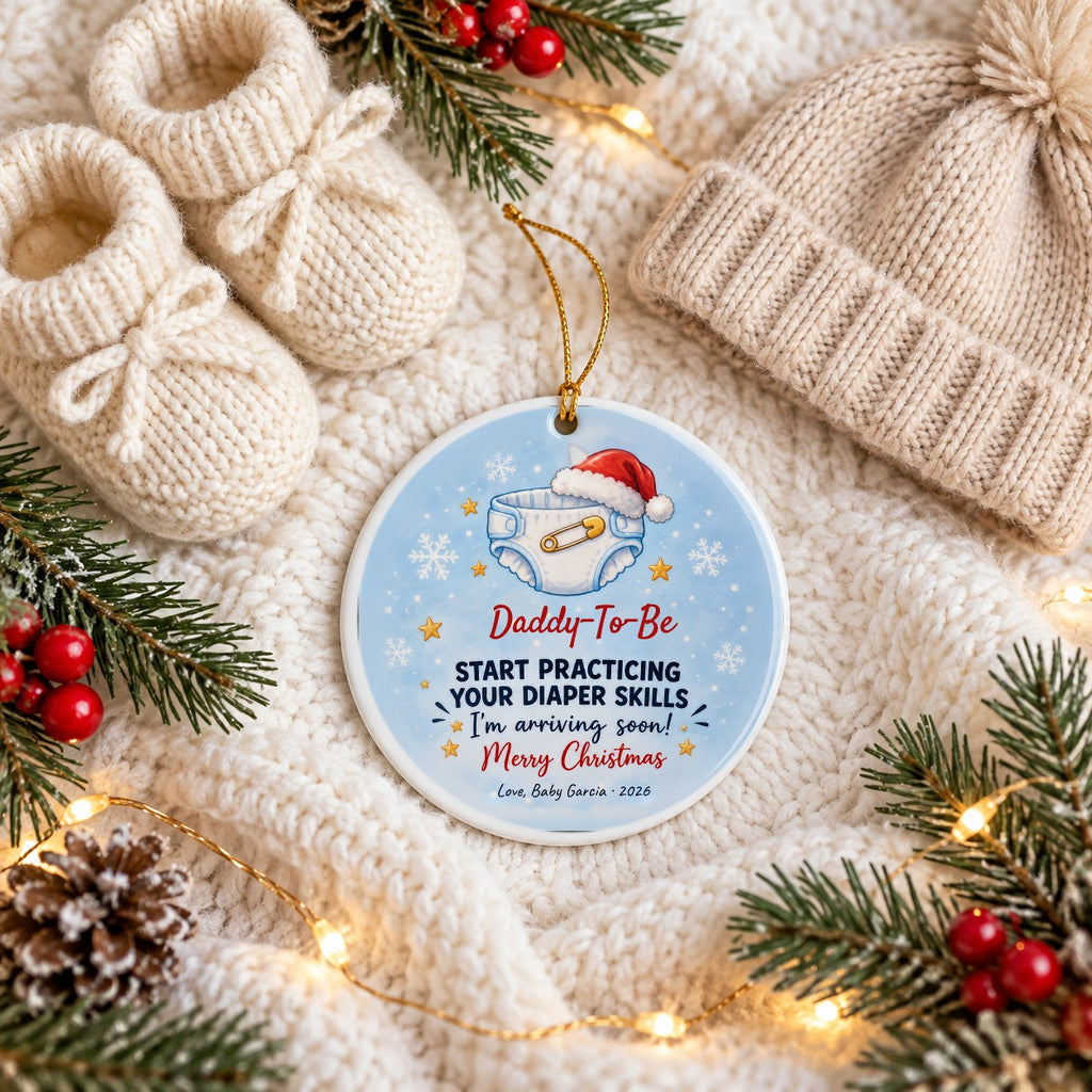Personalized Daddy, Start Practicing Your Diaper Skills ornament on a cozy knit blanket with baby booties