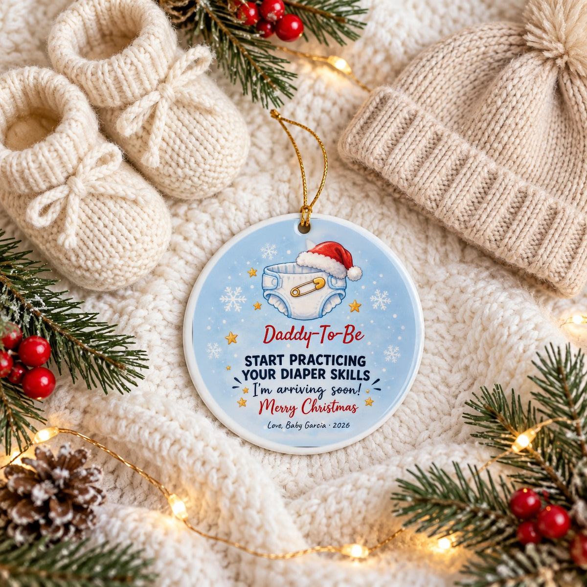 Personalized Daddy, Start Practicing Your Diaper Skills ornament on a cozy knit blanket with baby booties