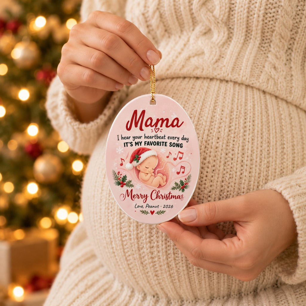 Personalized Mommy, Your Heartbeat Is My Favorite Song ornament held by a pregnant mom in front of her bump